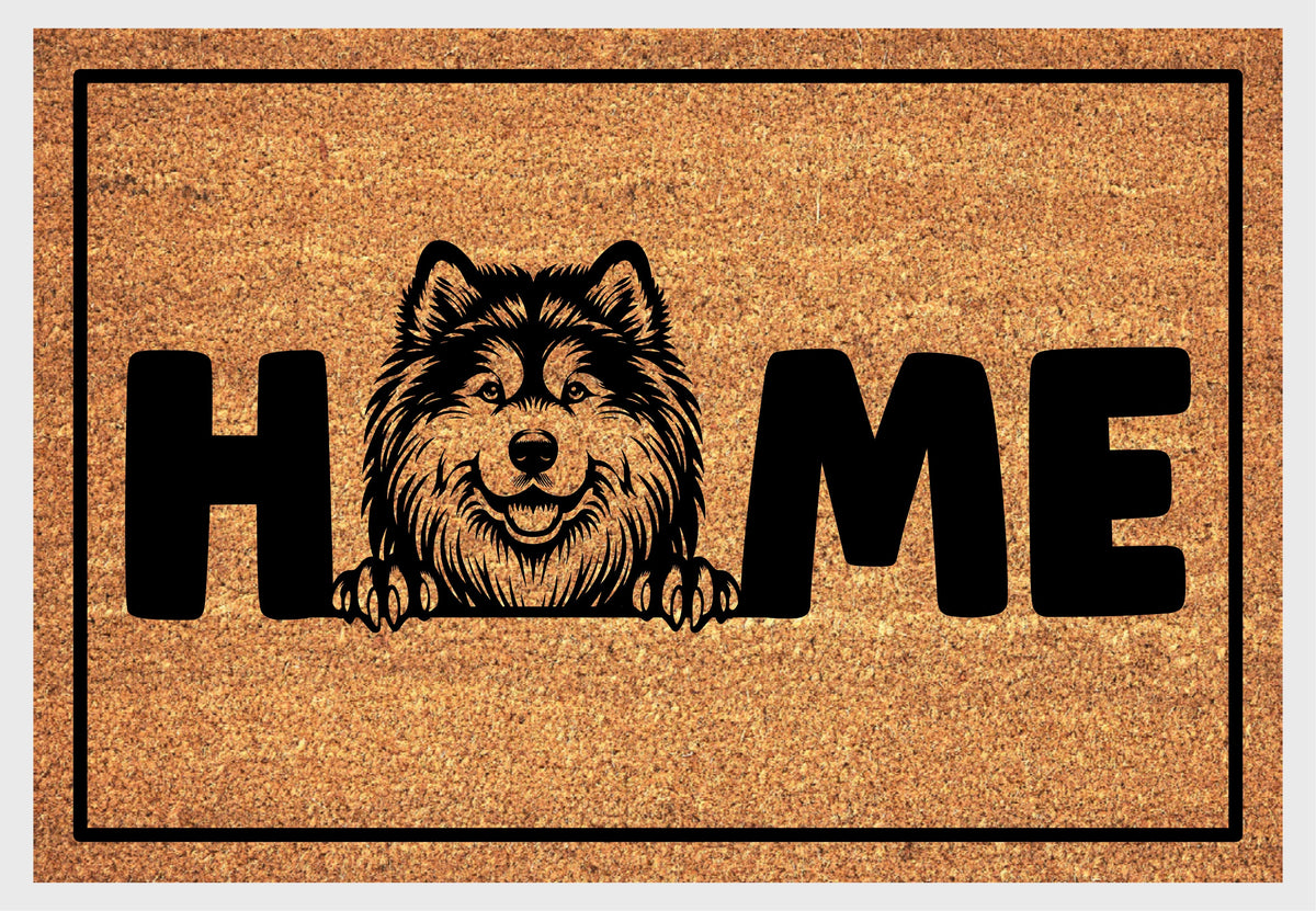 Alaskan Malamute doormat flat lay — Gentle Giant portrait illustration with thick double coat and paws replacing the letter O in HOME on a natural coir mat with black border