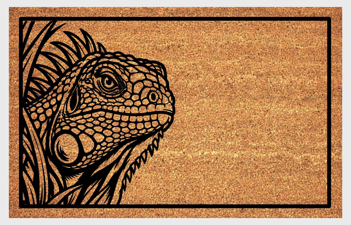 Iguana peeking coir doormat, front view showing textured scales, a prominent cheek scale and a crest of spines beside foliage.