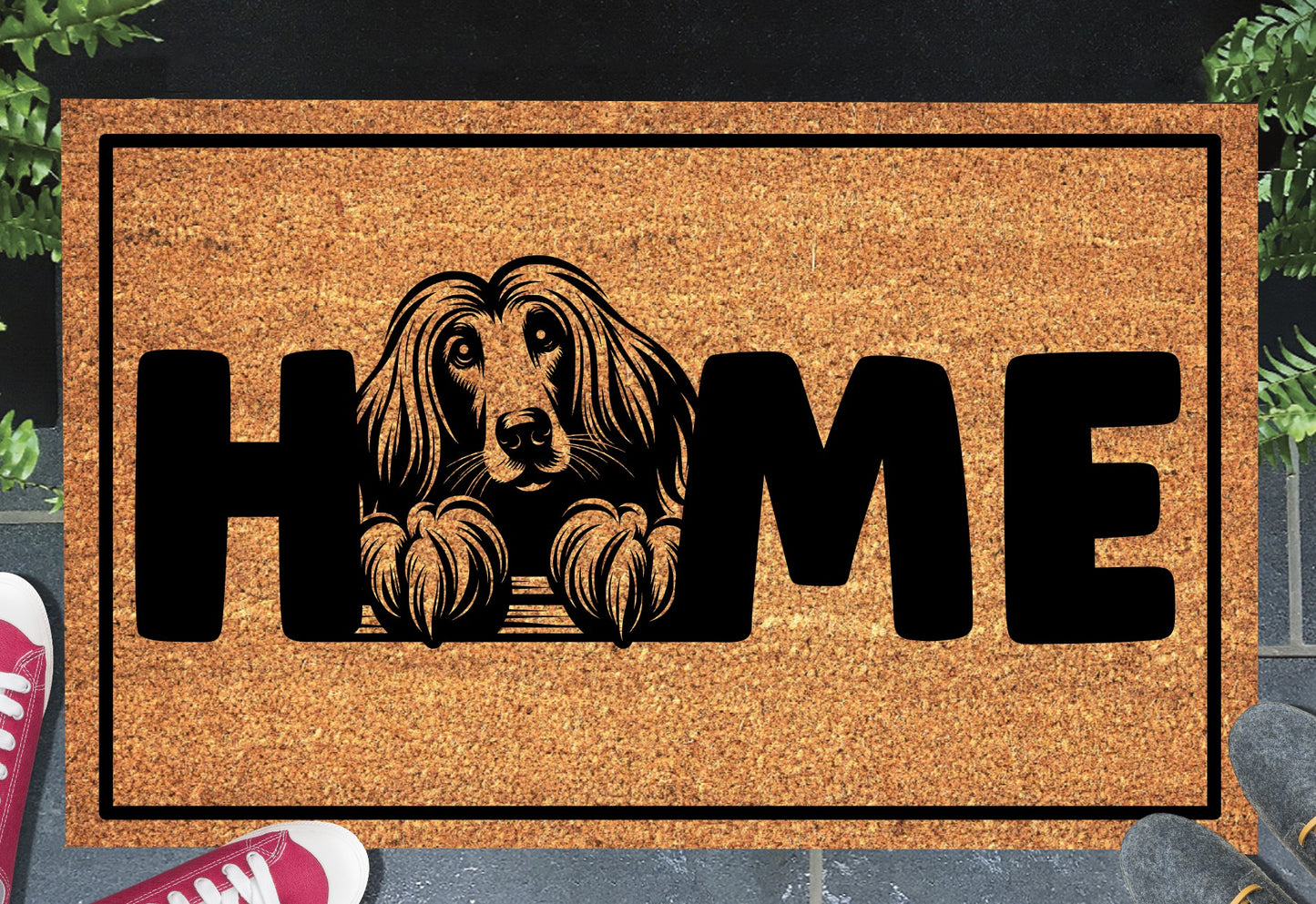 Afghan Hound coir doormat with portrait illustration of an Affie replacing the letter O in bold black HOME lettering, on a natural golden coir surface with black border, styled on a slate doorstep.