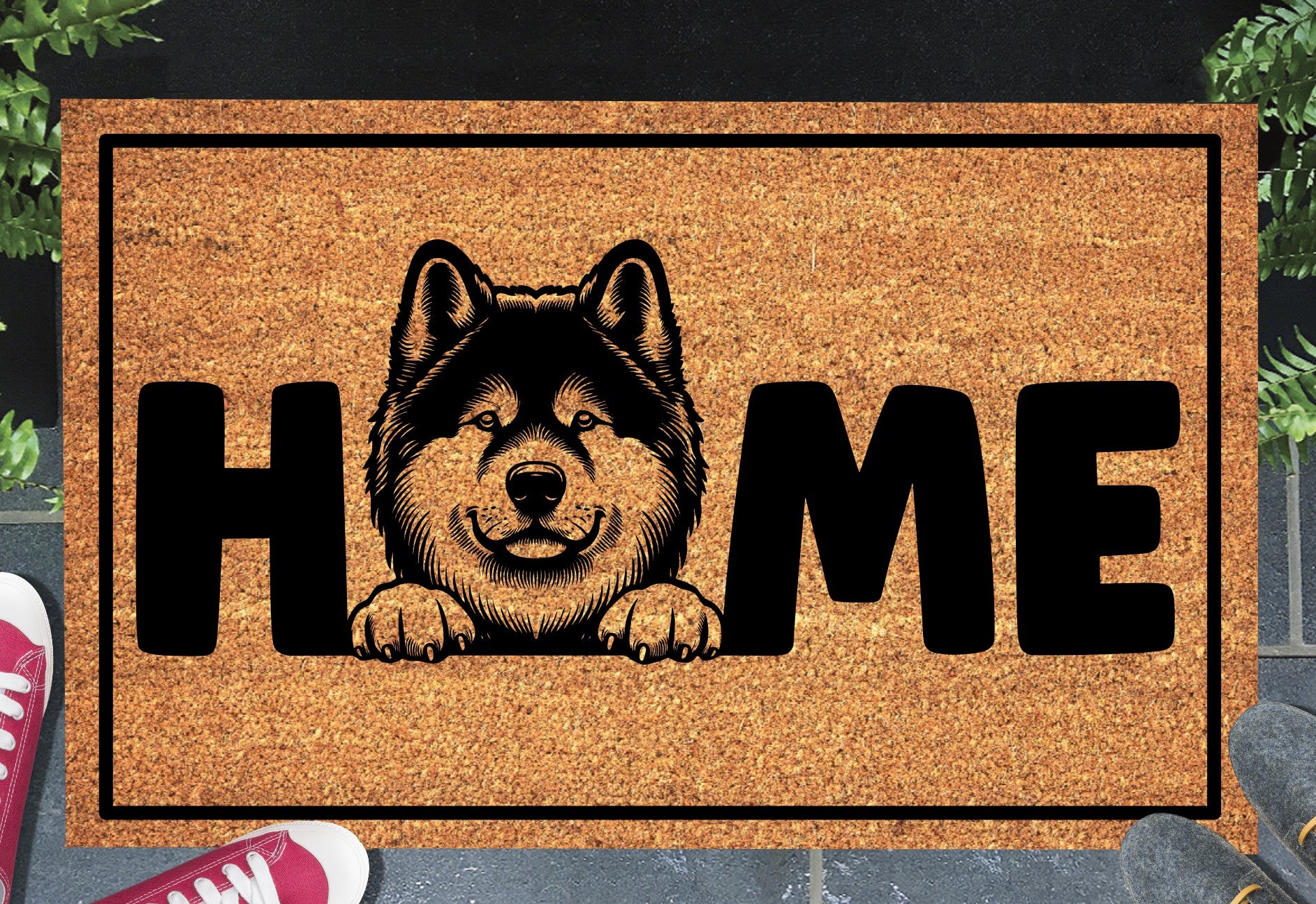 Akita coir doormat with portrait illustration of an Akita replacing the letter O in bold black HOME lettering, on a natural golden coir surface with black border, styled on a slate doorstep.