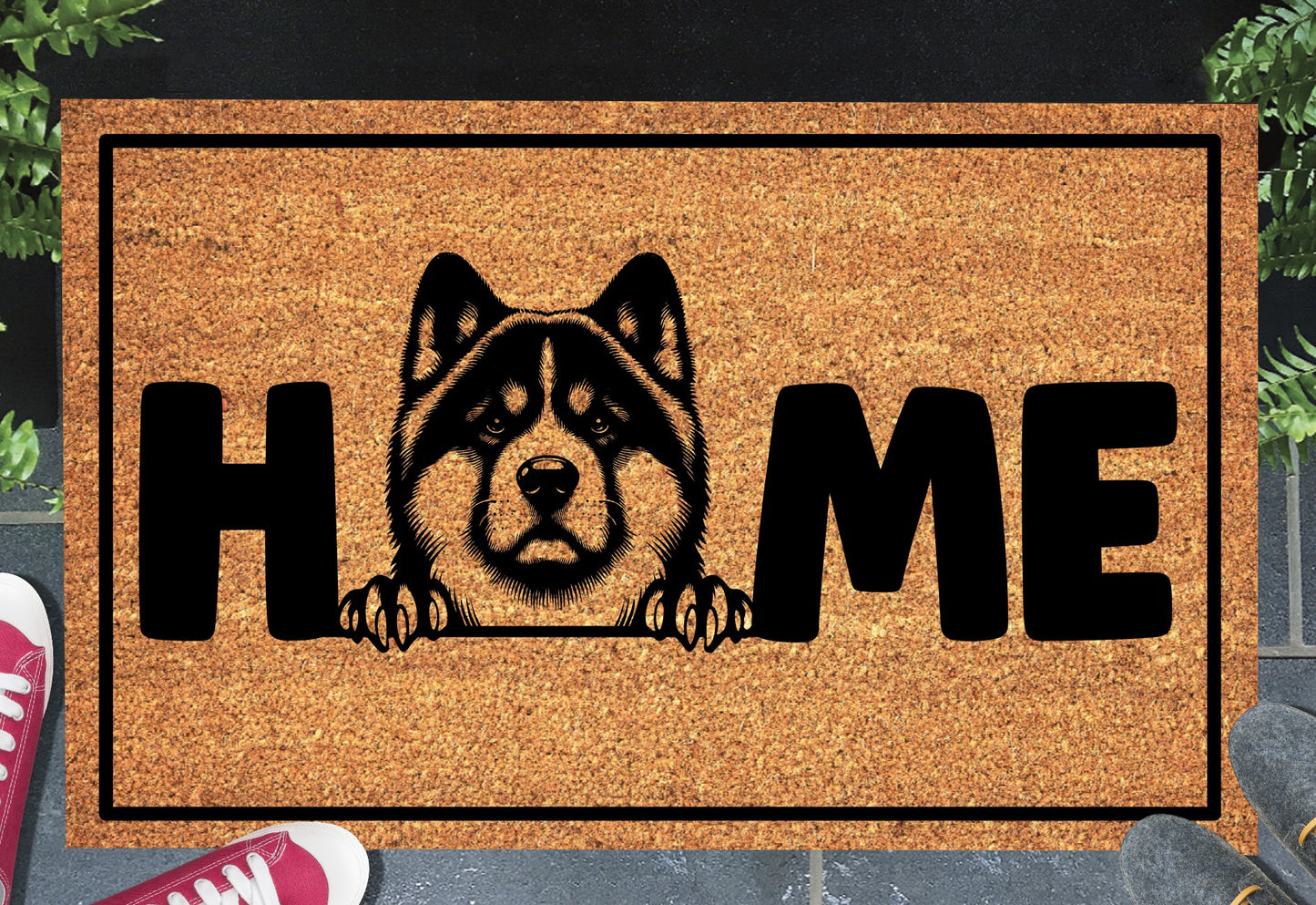 Akita coir doormat with portrait illustration of an Akita replacing the letter O in bold black HOME lettering, on a natural golden coir surface with black border, styled on a slate doorstep. 