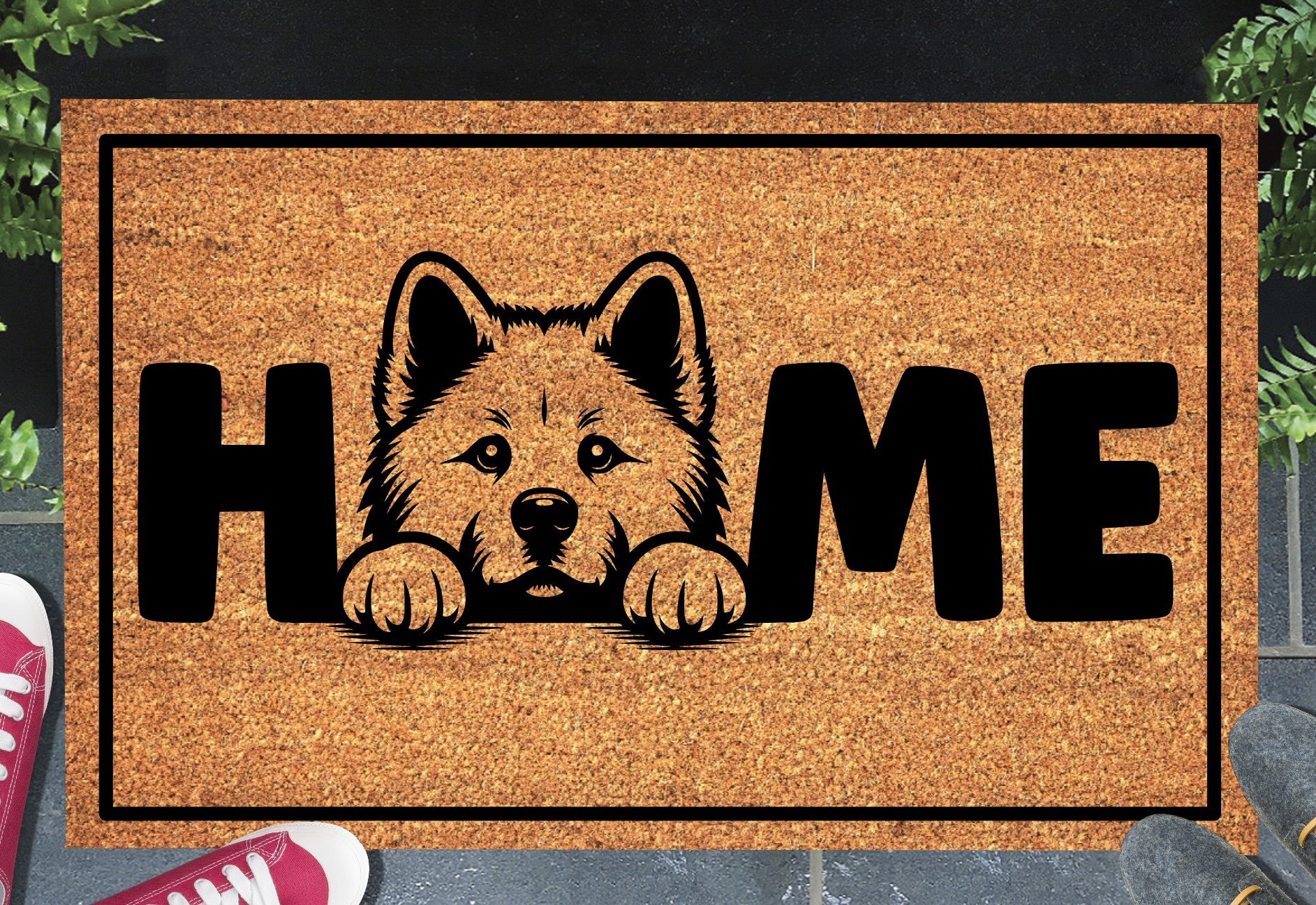 Akita coir doormat with portrait illustration of an Akita replacing the letter O in bold black HOME lettering, on a natural golden coir surface with black border, styled on a slate doorstep. 