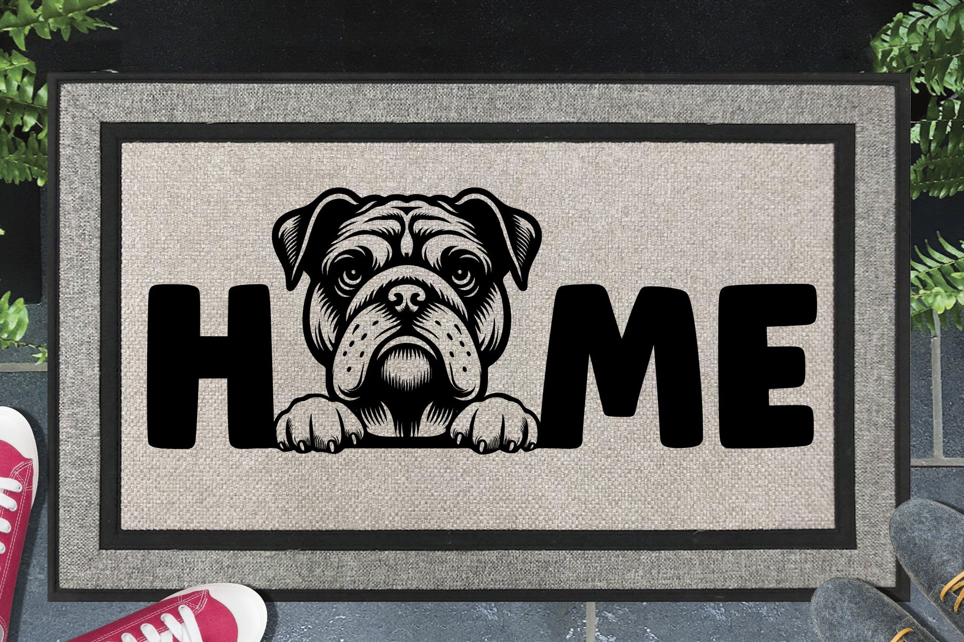 American Bulldog HOME all-weather doormat in doorway lifestyle shot — light grey linen-look woven polyester mat, wrinkle-faced American Bulldog head and paws illustration replaces the letter O in HOME, 18x30 size shown