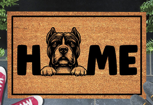 American Bully coir doormat in a doorway — Bully illustration replacing the letter O in "HOME" on natural coir, front door entryway