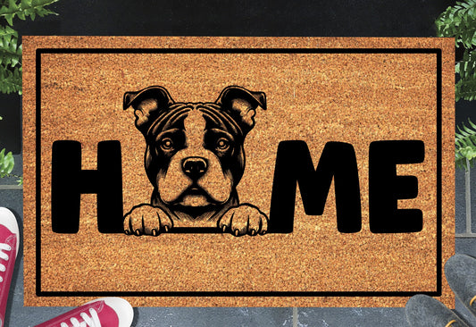 American Bully coir doormat in a doorway — Classic Bully illustration replacing the letter O in "HOME" on natural coir, front door entryway