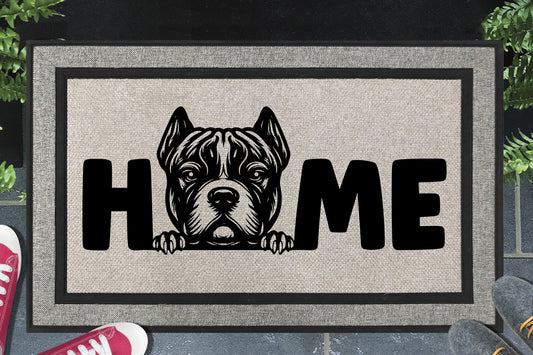 XL American Bully all-weather doormat in a doorway — Bully XL illustration replacing the letter O in "HOME", UV-cured inks on woven polyester, front door entryway