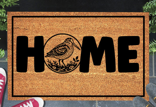 American Woodcock doormat #1 shown at front door entryway — natural coir with non-slip backing