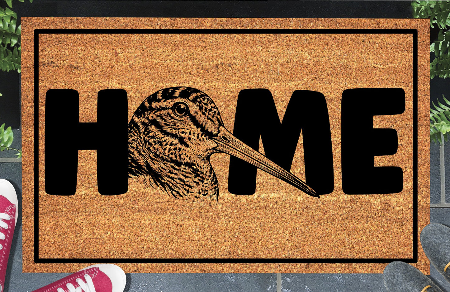 American Woodcock coir doormat in entryway — detailed Timberdoodle head portrait with extended bill replaces the letter O in HOME on natural coir
