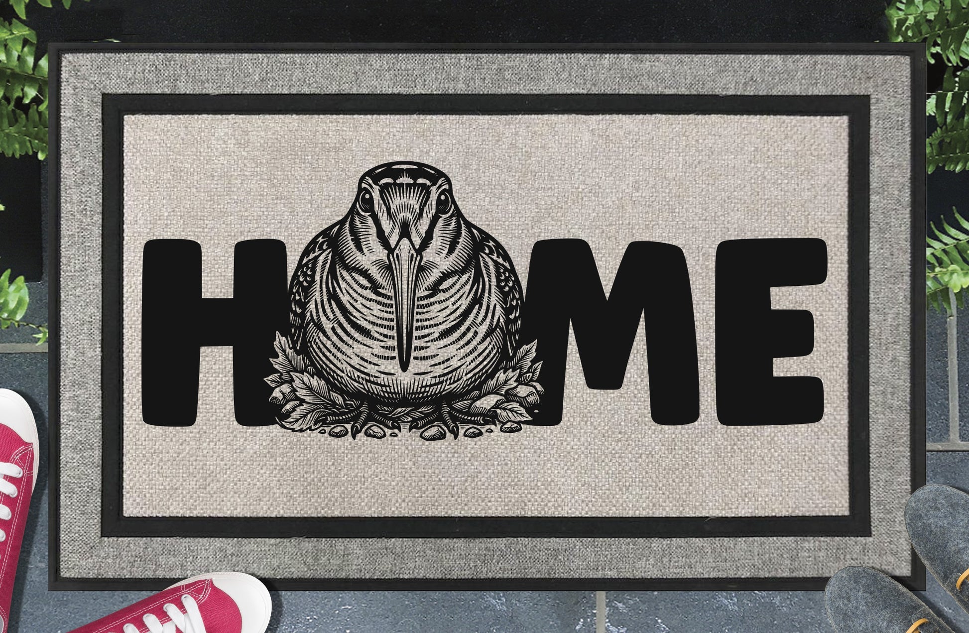 American Woodcock all-weather doormat — detailed Timberdoodle head portrait with extended bill replaces the letter O in HOME, woven polyester with linen look finish