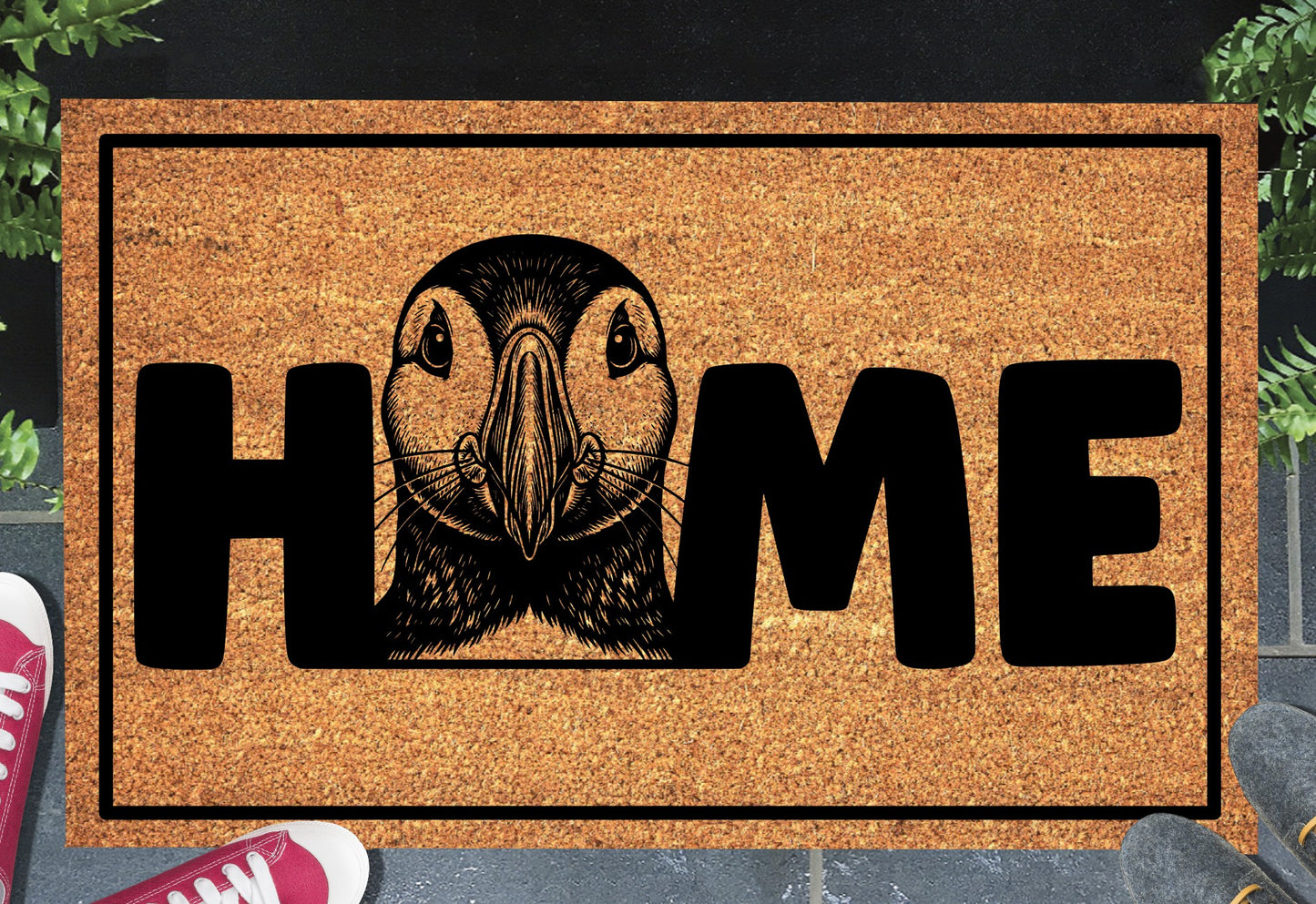 Atlantic Puffin coir doormat in a doorway — Puffin illustration replacing the letter O in "HOME" on natural coir