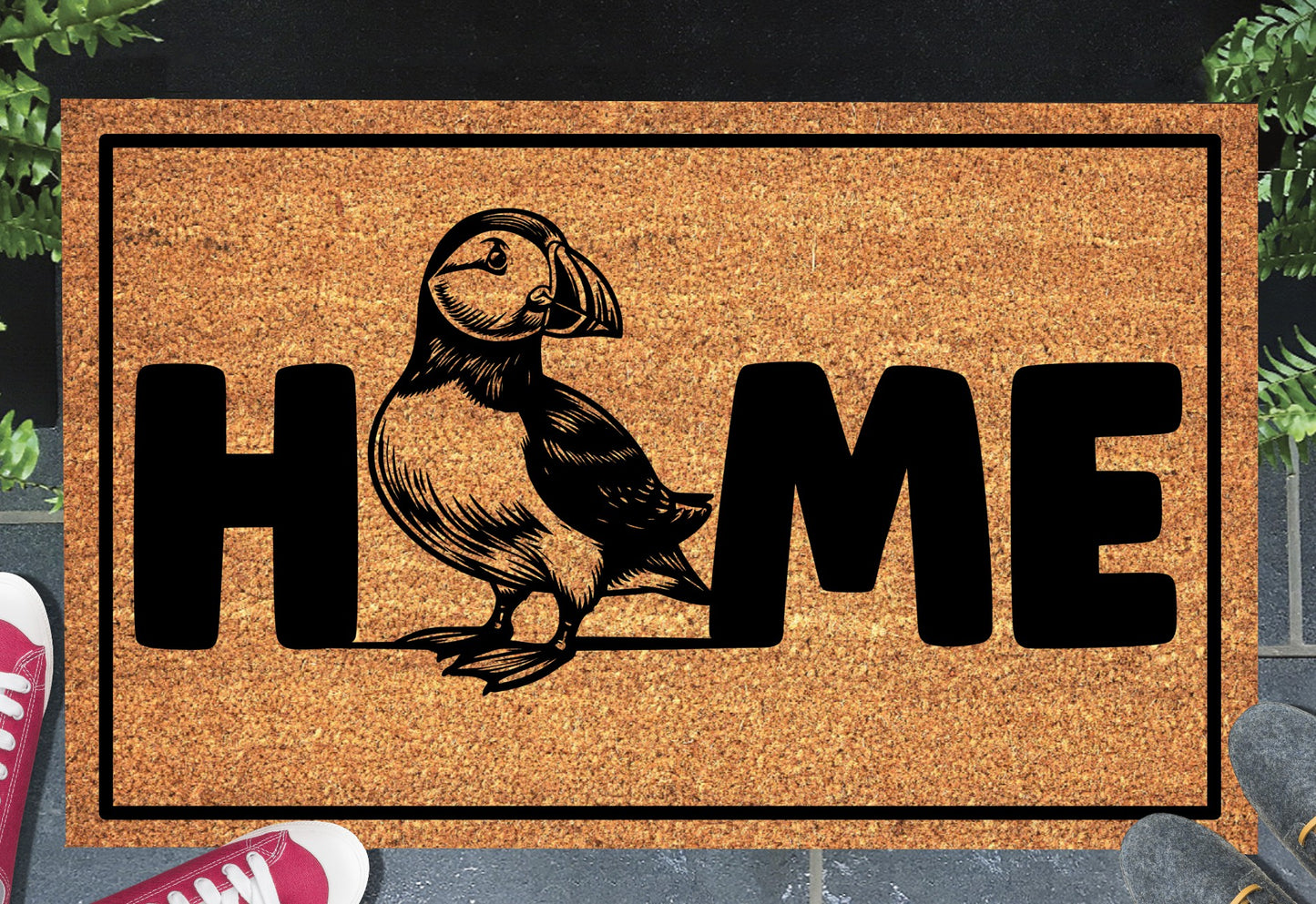 Atlantic Puffin coir doormat in a doorway — full-body Puffin illustration replacing the letter O in "HOME" on natural coir, front door entryway