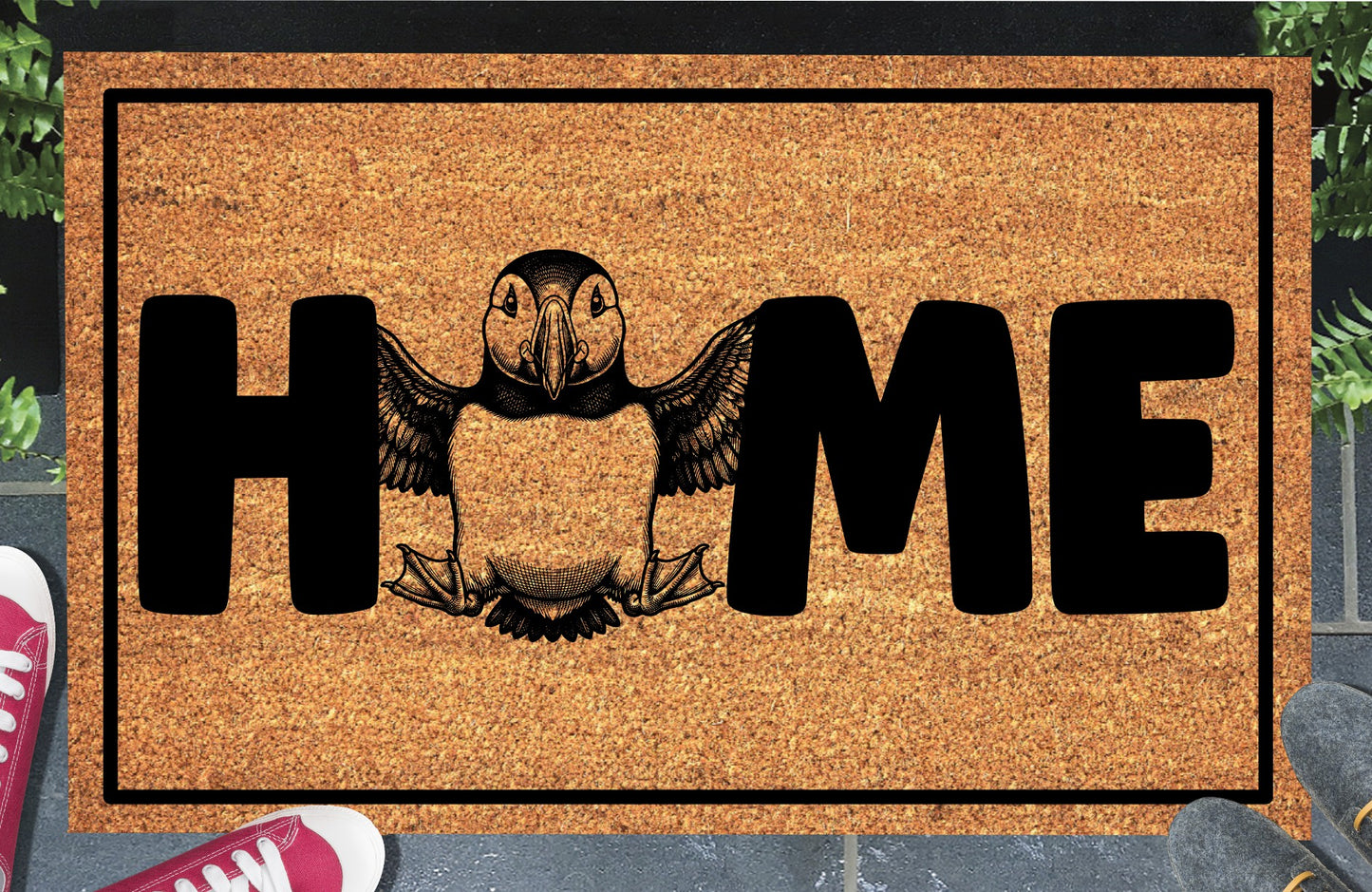 Atlantic Puffin Sea Parrot coir doormat in entryway — full-body Atlantic Puffin with wings spread replaces the letter O in HOME on a natural coir welcome mat