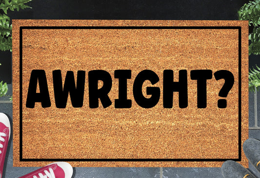 Awright? doormat with bold British greeting design displayed at a front door entryway — available in 16x24, 18x30, and 24x36 inches