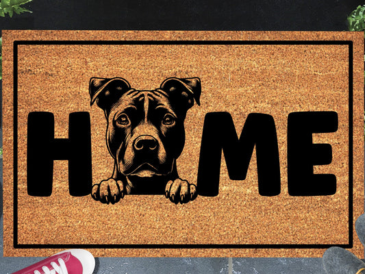 American Pit Bull Terrier coir doormat in a doorway — Pittie illustration replacing the letter O in "HOME" on natural coir, front door entryway
