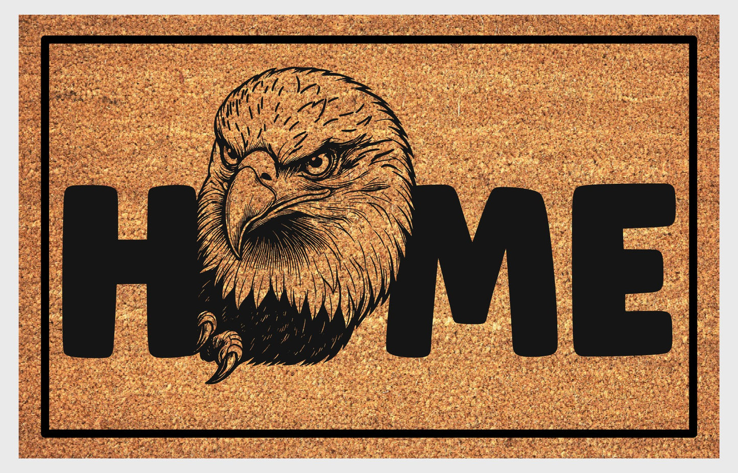 American Bald Eagle HOME doormat flat lay — natural tan coir mat, large angled Bald Eagle head and talon illustration replaces the letter O in HOME, available in 16x24, 18x30, and 24x36