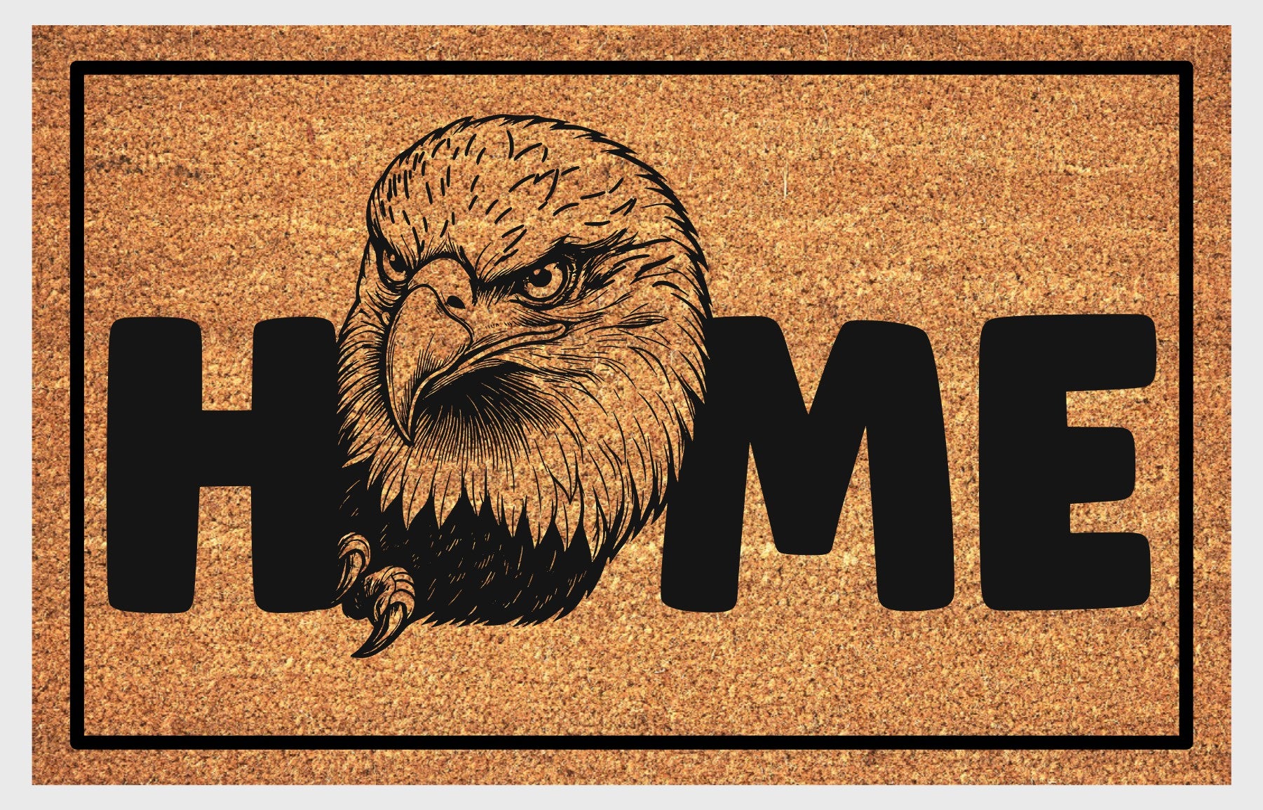 American Bald Eagle HOME doormat flat lay — natural tan coir mat, large angled Bald Eagle head and talon illustration replaces the letter O in HOME, available in 16x24, 18x30, and 24x36