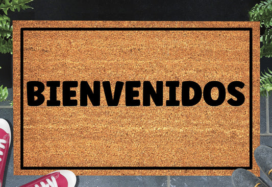 Bienvenidos Spanish welcome doormat placed at front door entrance