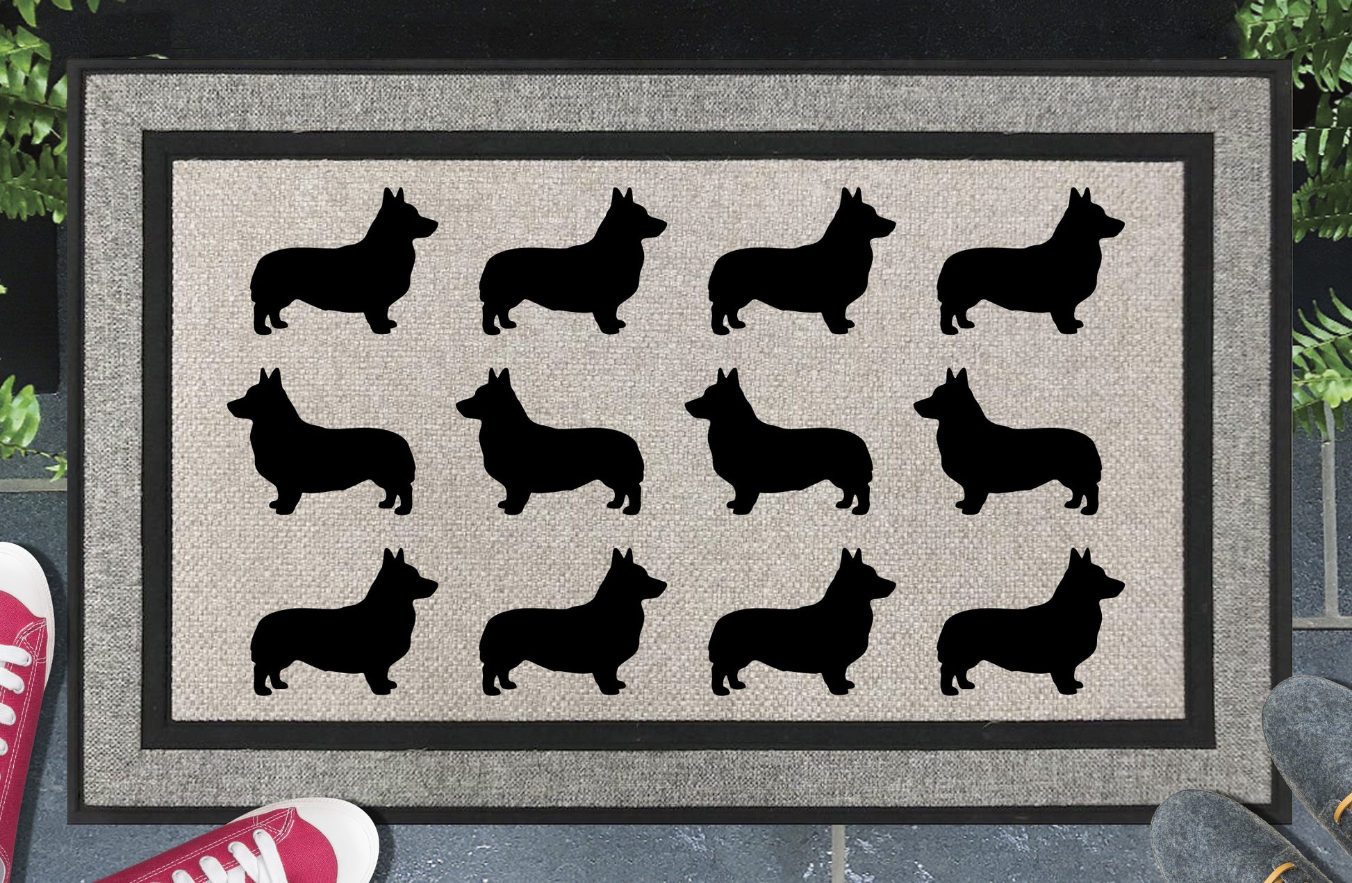Corgi Parade all-weather doormat in a doorway setting — rows of Corgi silhouettes with low-slung body, perky ears, and sturdy frame in a repeating pattern on a woven polyester mat with black border