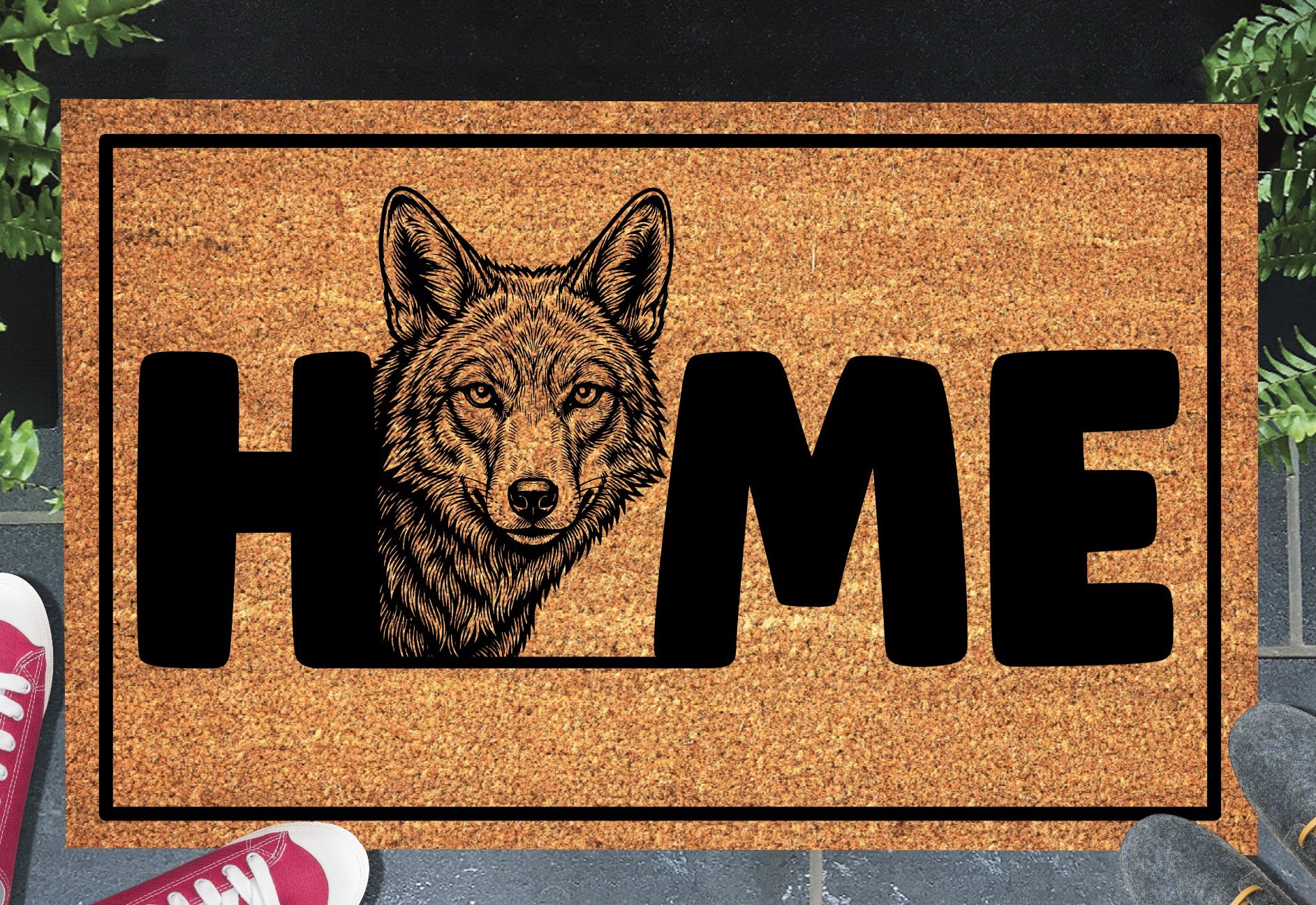 Coyote Doormat #2 shown on a front doorstep — second alternate portrait-style coyote illustration with HOME lettering on a natural coir mat with black border