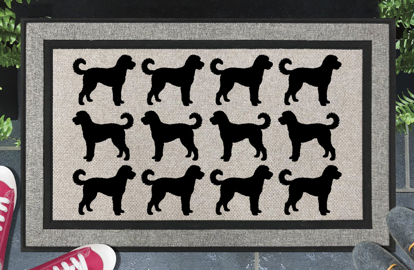 Goldendoodle Parade all-weather doormat in a doorway setting — rows of Doodle silhouettes with curly coat and upright tail in a repeating pattern on a woven polyester mat with black border