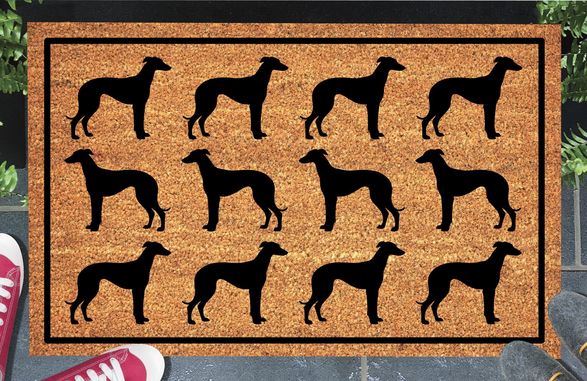 Greyhound Parade coir doormat in a doorway setting — rows of Greyhound silhouettes with deep chest and tucked waist in a repeating pattern on a natural coir mat with black border