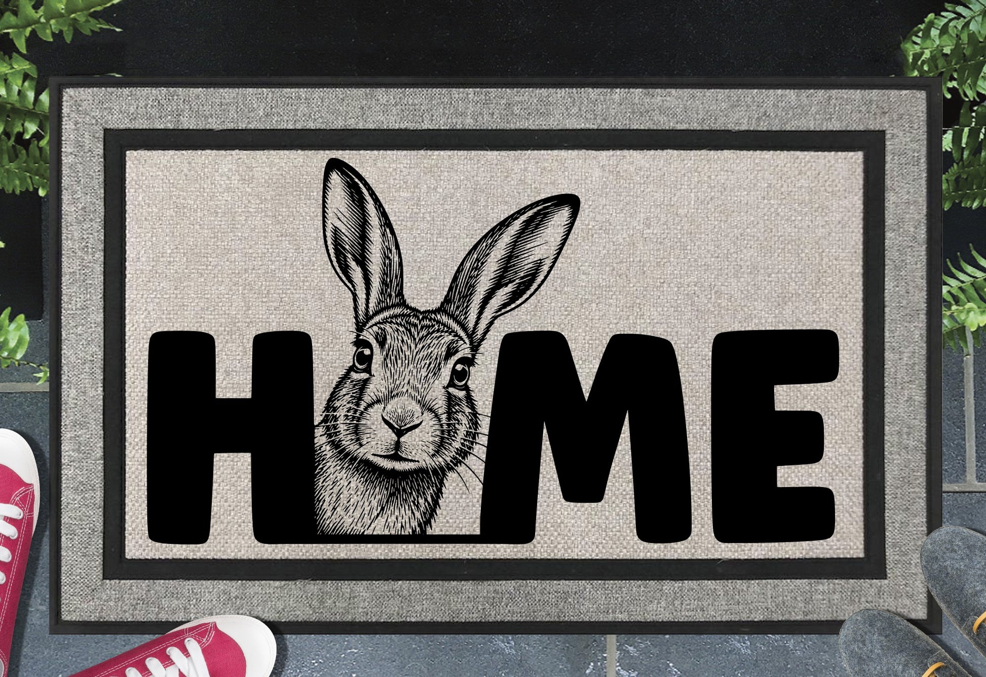Irish Hare all-weather doormat styled at a front doorway — hare peeking from the edge of HOME text on grey woven polyester with rubber border