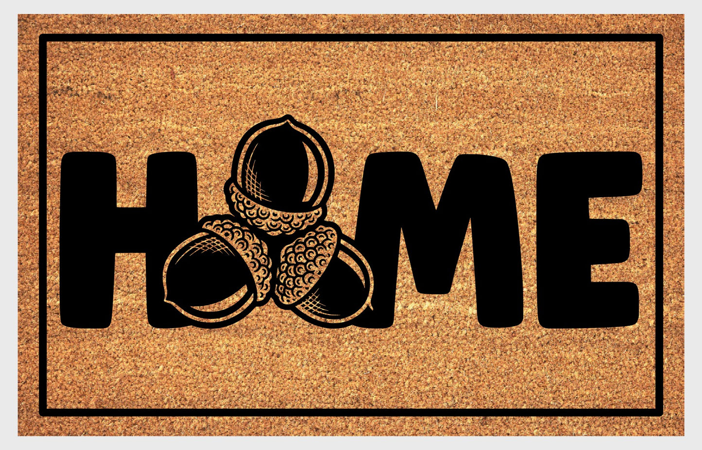 Sessile Oak Welsh Oak acorn coir doormat with bold black HOME lettering and cluster of three acorn illustrations replacing the letter O, on a natural golden coir surface with black border, plain background.