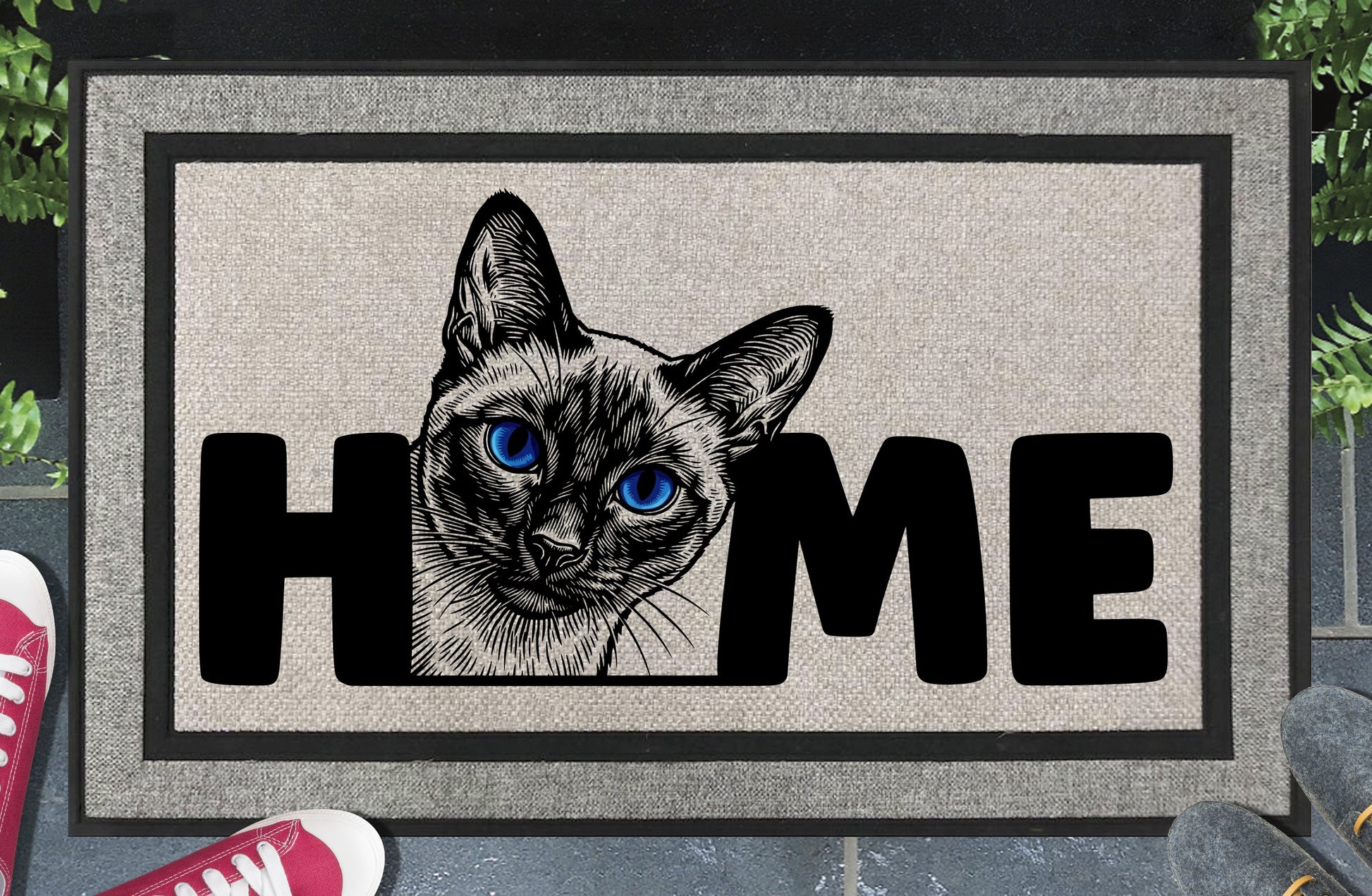 Siamese Cat all-weather doormat in a doorway setting — Meezer portrait illustration with piercing blue eyes replacing the letter O in HOME on a woven polyester mat with grey linen look finish and black border