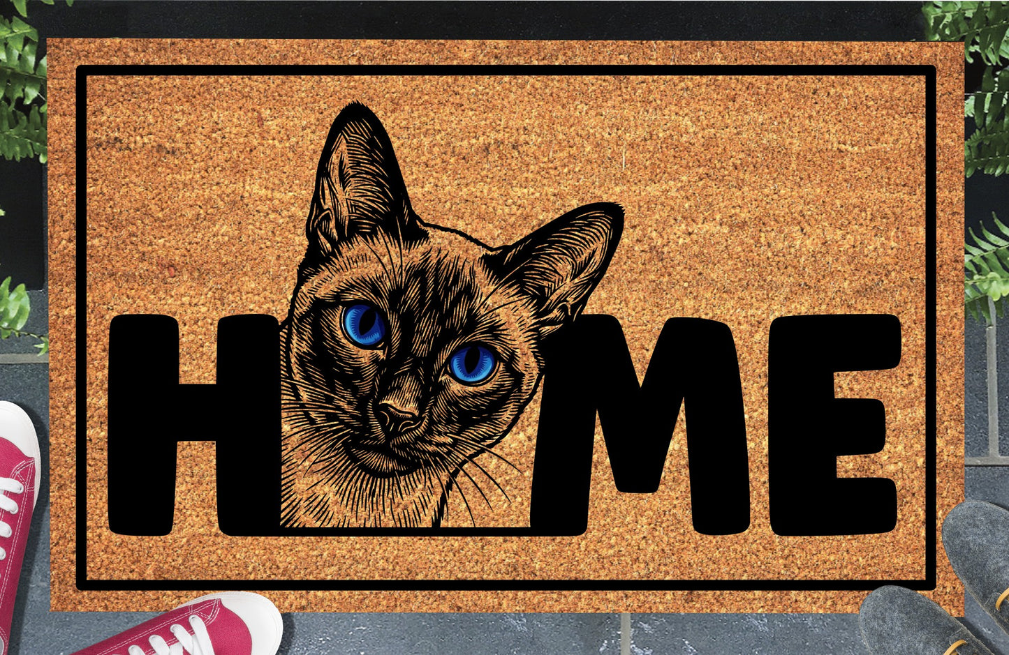 Siamese cat doormat in a doorway setting — Meezer portrait illustration with piercing blue eyes replacing the letter O in HOME on a natural coir mat with black border
