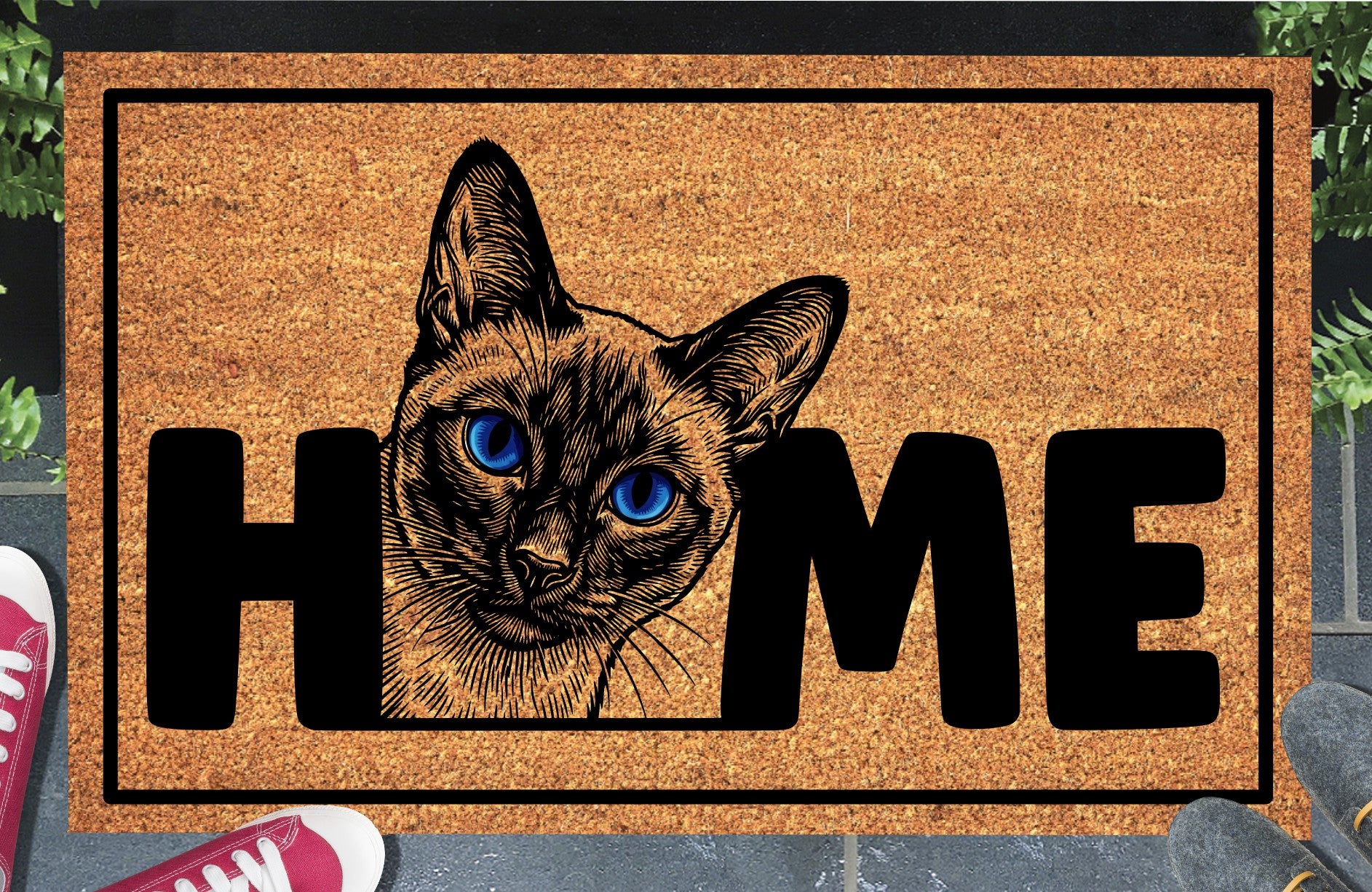 Siamese cat doormat in a doorway setting — Meezer portrait illustration with piercing blue eyes replacing the letter O in HOME on a natural coir mat with black border