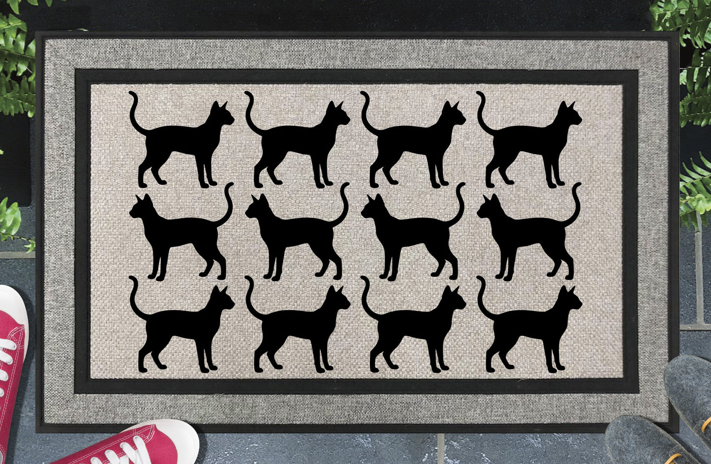 Siamese Cat Parade all-weather doormat in a doorway setting — rows of Meezer silhouettes with large ears and upright tail in a repeating pattern on a woven polyester mat with grey linen look finish and black border