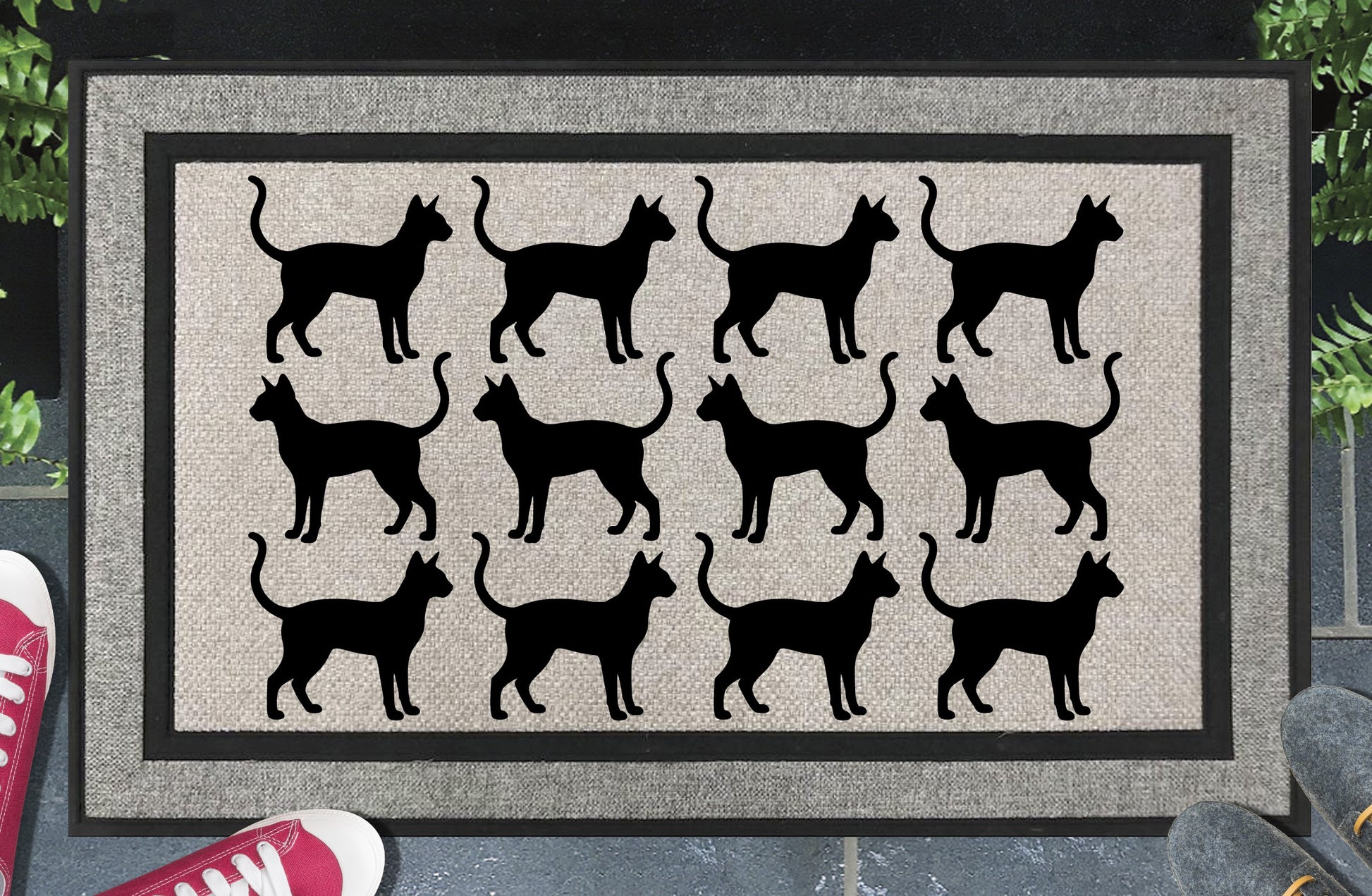 Siamese Cat Parade all-weather doormat in a doorway setting — rows of Meezer silhouettes with large ears and upright tail in a repeating pattern on a woven polyester mat with grey linen look finish and black border