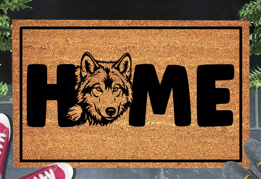 Wolf Doormat #4 shown on a front doorstep — fourth alternate portrait-style wolf illustration with HOME lettering on a natural coir mat with black border