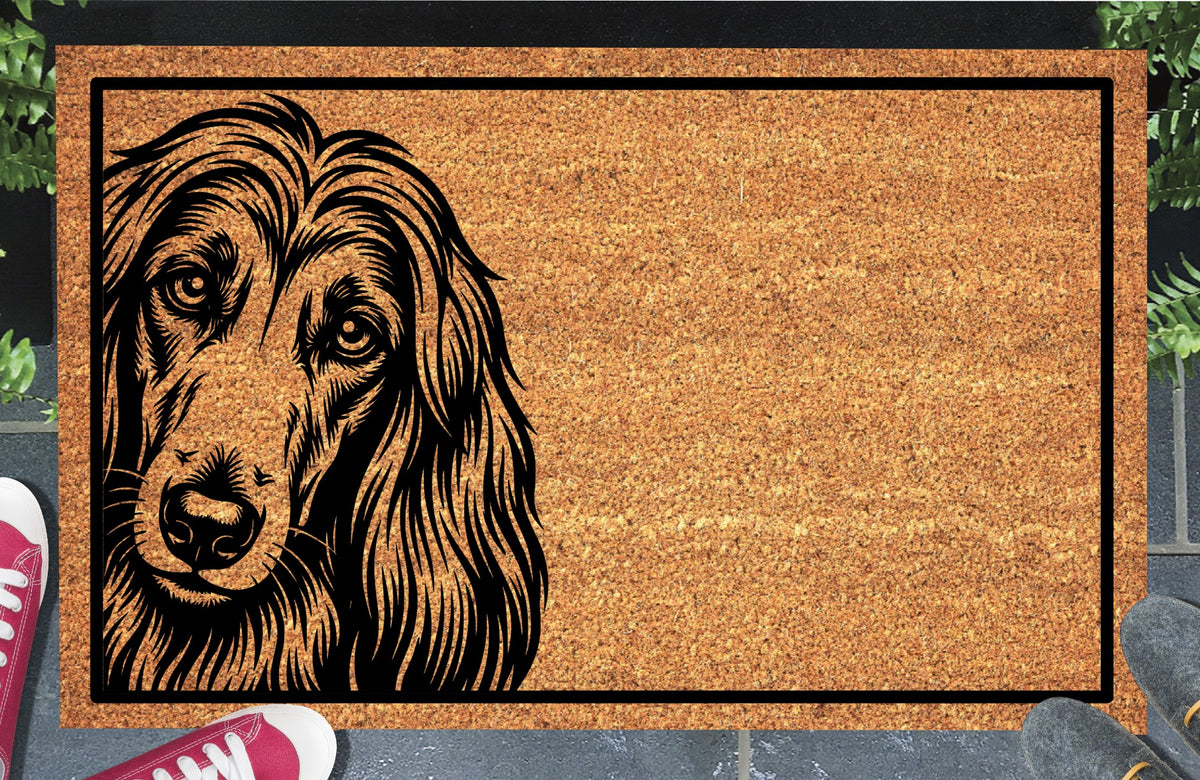 Afghan Hound Peeking coir doormat with a long-haired Afghan Hound illustration peeking from the left edge and a black border, shown in a doorway