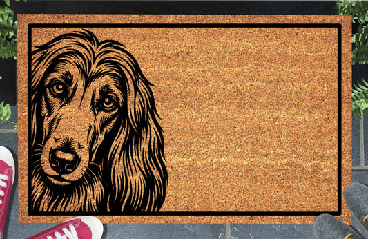 Afghan Hound Peeking coir doormat with a long-haired Afghan Hound illustration peeking from the left edge and a black border, shown in a doorway