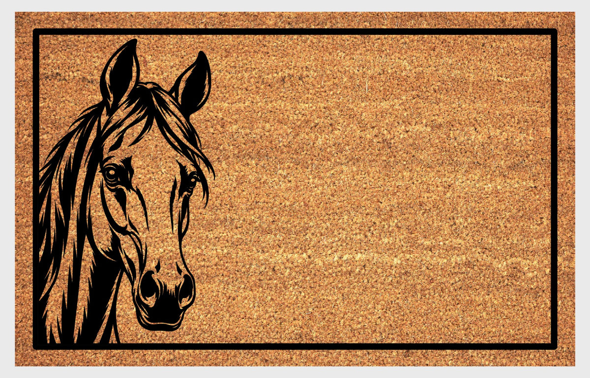 Close-up of an Arabian Horse peeking natural coir doormat, showing its finely drawn face, upright ears, flowing mane and black rectangular border.