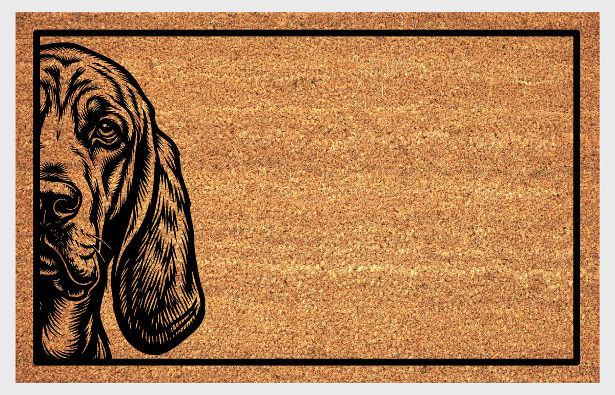 Bloodhound Peeking coir doormat #2 featuring one expressive eye, a wrinkled muzzle and long ear peeking from the left, flat front view
