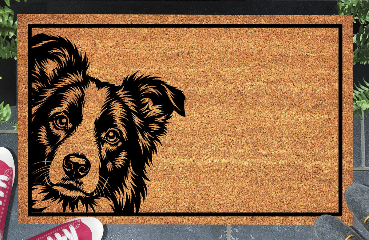 Border Collie Peeking Doormat #1, natural coir welcome mat with a Collie peeking from the left edge and a black rectangular border, shown at a doorway.