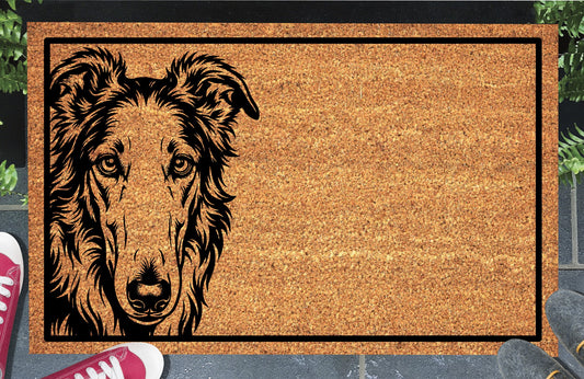 Borzoi Peeking Doormat #1, natural coir welcome mat with a long-faced Borzoi peeking from the left edge inside a black rectangular border, shown at a doorway.