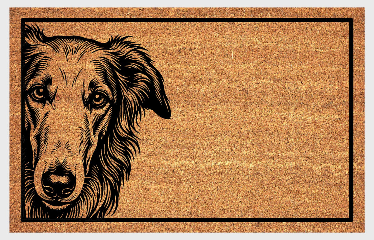Borzoi Peeking Doormat #2, close-up Borzoi portrait with folded ears and wavy neck feathering on natural coir, framed by a black rectangular border on a white background.
