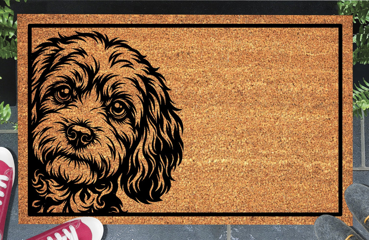 Cavapoo Peeking coir doormat #1 with a curly-coated Cavoodle portrait at the left edge and black rectangular border, shown on a doorstep