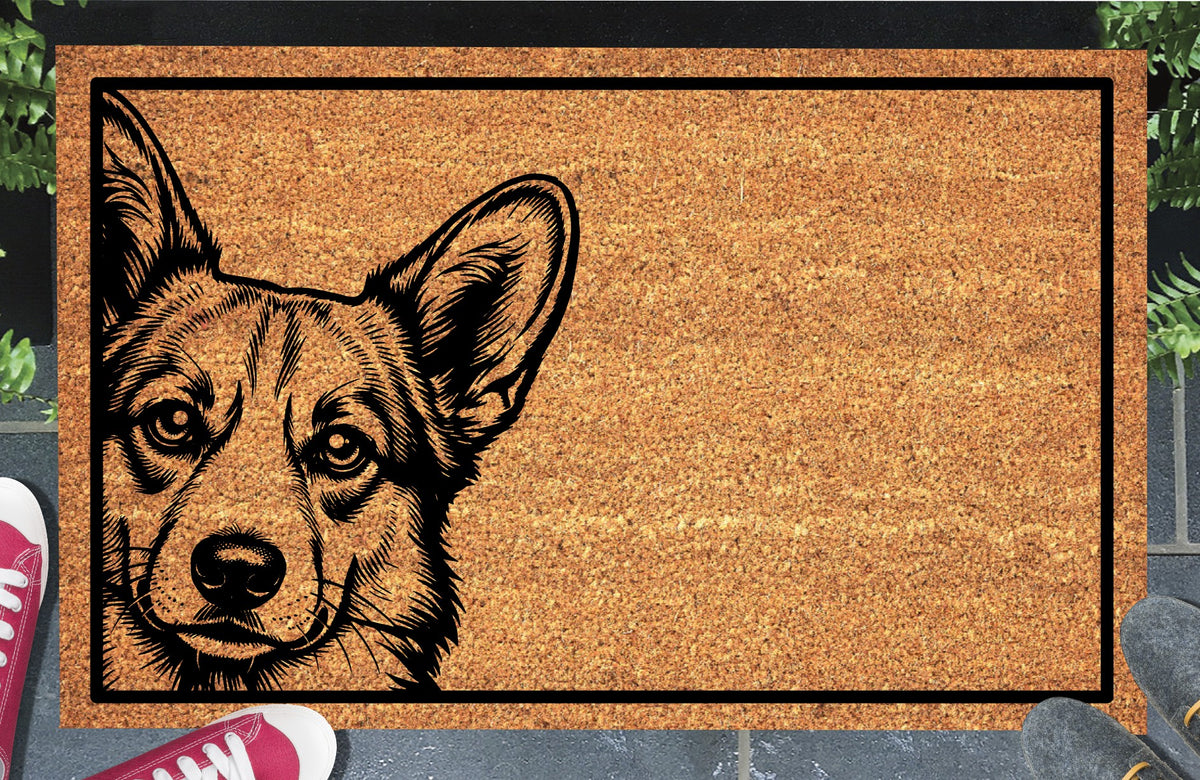 Corgi Peeking Doormat #1, Pembroke Welsh Corgi portrait peeking from the left edge within a black border on natural coir, styled at an entryway.