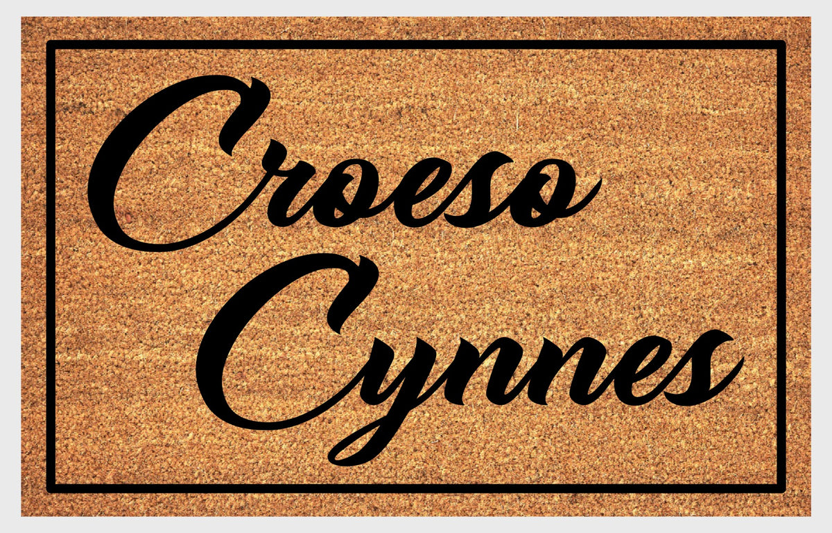 Close-up of Croeso Cynnes Welsh doormat showing natural coir fiber texture and lettering detail