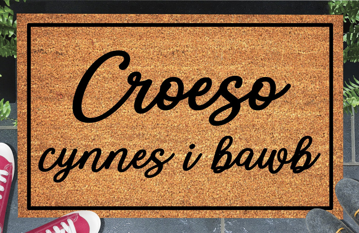 Croeso Cynnes i Bawb coir doormat — Welsh "warm welcome to all" mat in bold lettering, natural coconut fiber, non-slip rubber backing