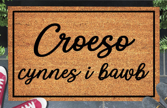 Croeso Cynnes i Bawb coir doormat — Welsh "warm welcome to all" mat in bold lettering, natural coconut fiber, non-slip rubber backing
