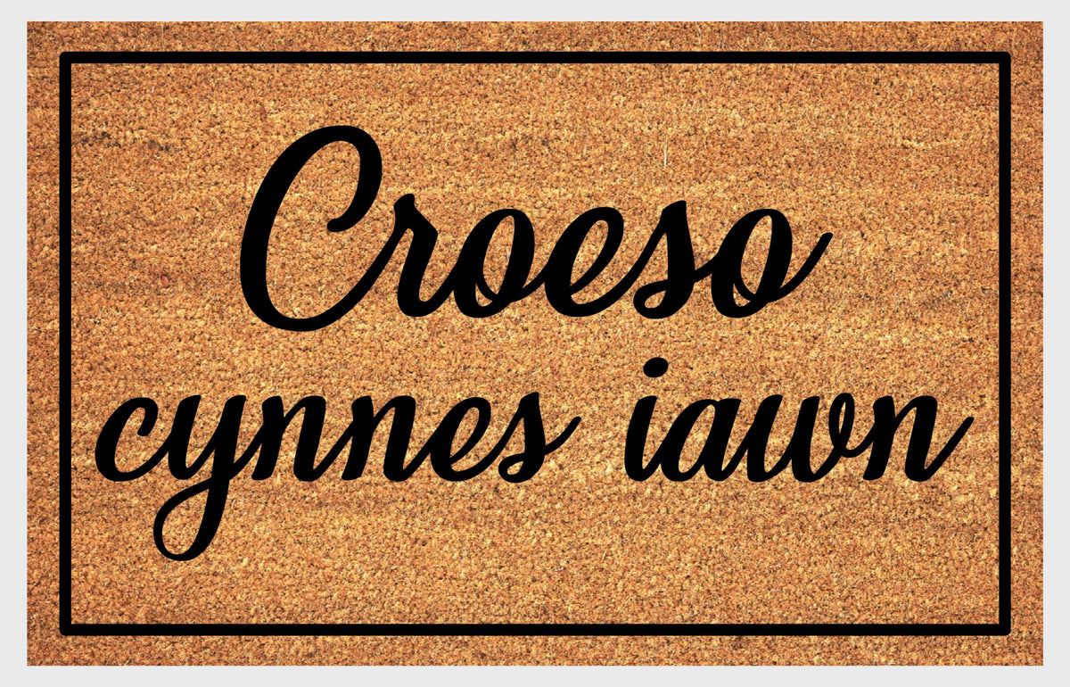 Close-up of Croeso Cynnes Iawn Welsh doormat showing natural coir fiber texture and lettering detail