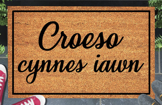 Croeso Cynnes Iawn coir doormat — Welsh "very warm welcome" mat in bold lettering, natural coconut fiber, non-slip rubber backing