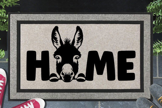 Donkey all-weather doormat — donkey illustration replacing the letter O in HOME, woven polyester, non-slip backing, flat lay 