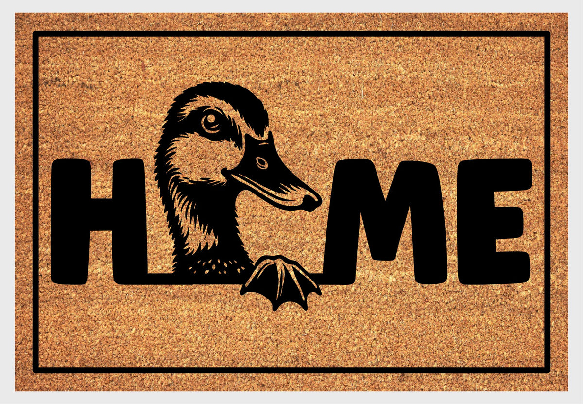 Duck Doormat #2 Quacker Welcome Mat coir doormat — close-up of duck illustration replacing the letter O in HOME on natural coir