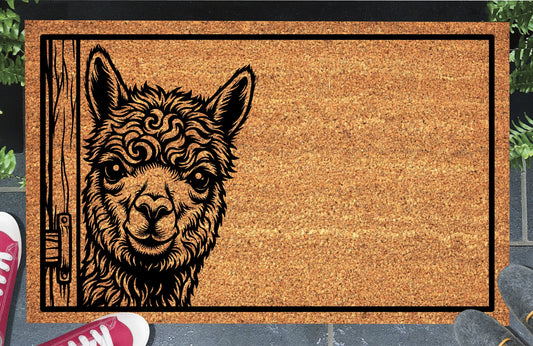 Huacaya Alpaca peeking coir doormat with a fluffy Alpaca beside a wooden door and black rectangular border, styled at an entryway.